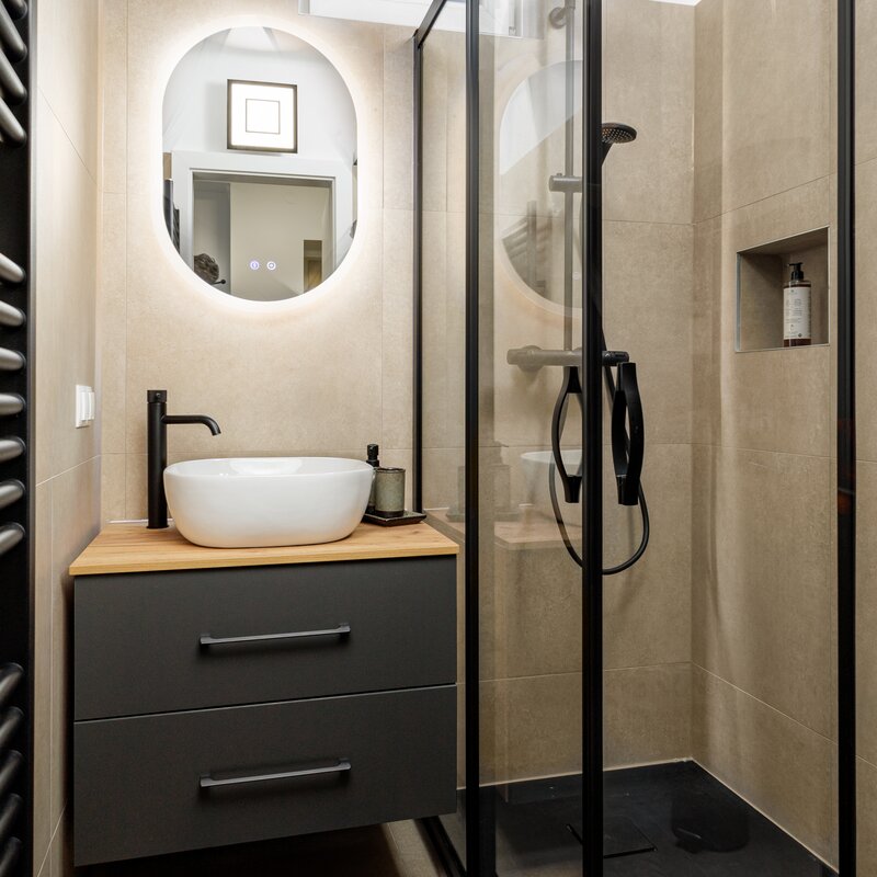 Completely renovated bathroom with walk-in shower and black fittings