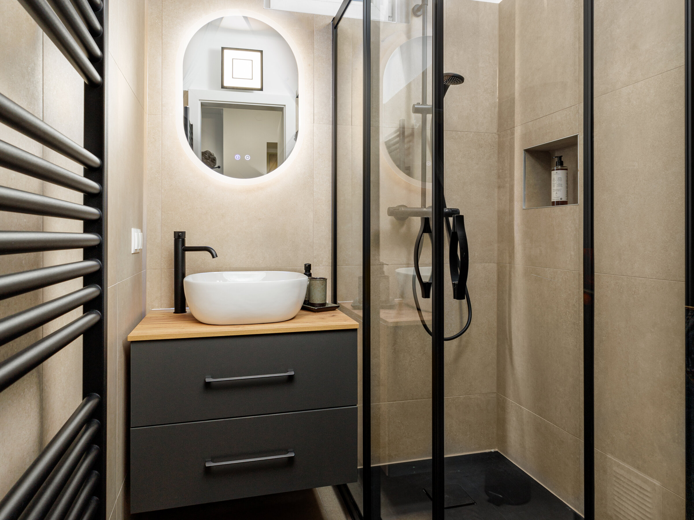 Completely renovated bathroom with walk-in shower and black fittings