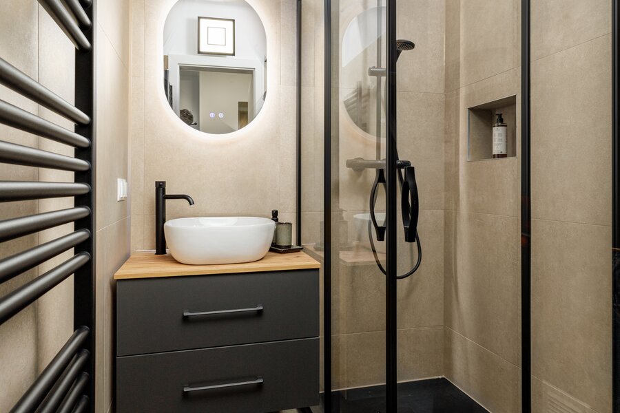 Completely renovated bathroom with walk-in shower and black fittings