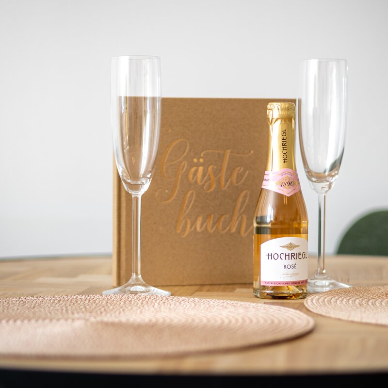 Welcome gift with champagne bottle and guest book
