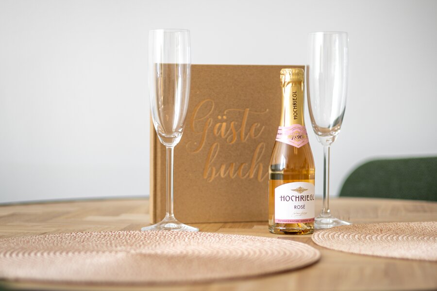 Welcome gift with champagne bottle and guest book