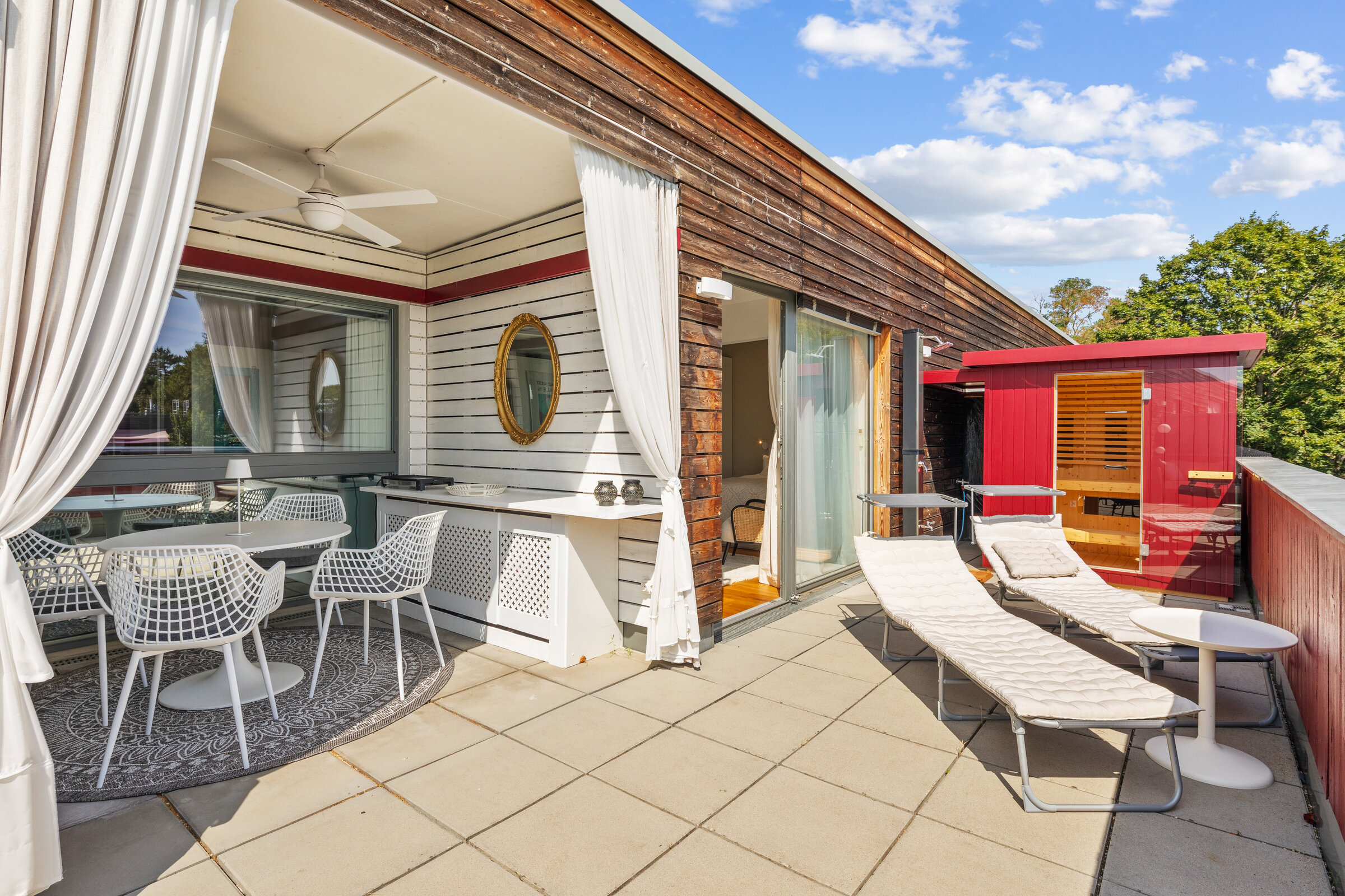 terrace with loggia and outdoor dining, grill, sauna and entrance to the bedroom
