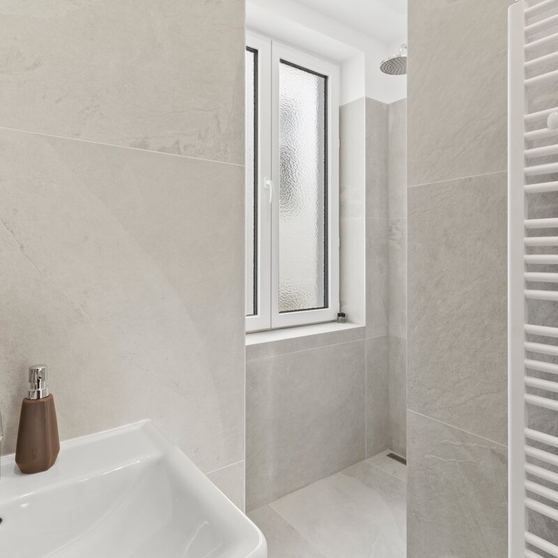 Badezimmer mit Dusche und Waschmaschine