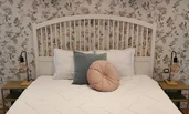double bed with vintage wallpaper