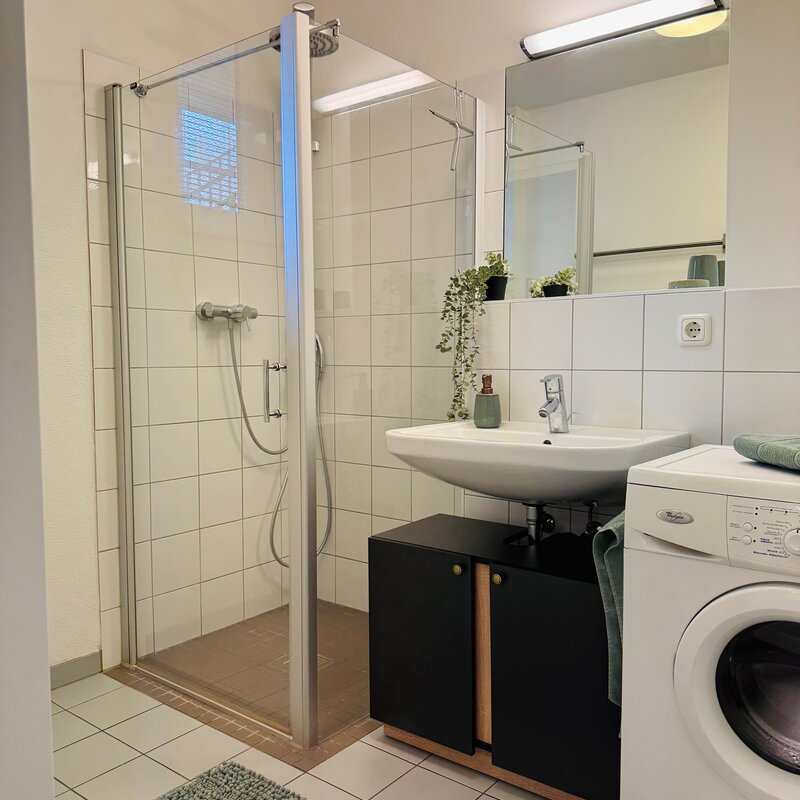with large shower and washing machine