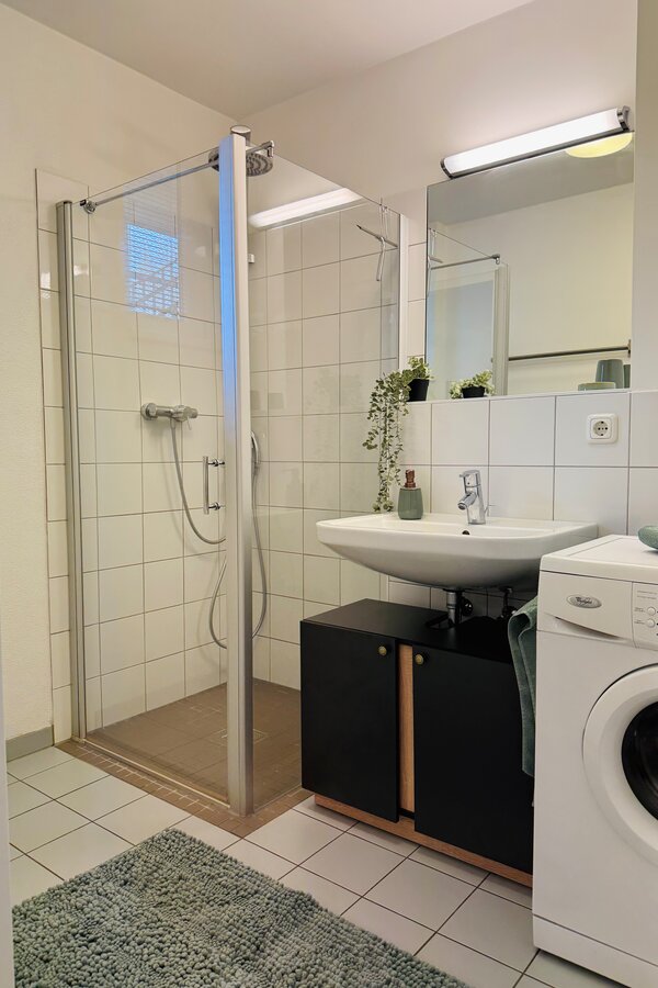 with large shower and washing machine