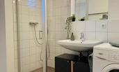 with large shower and washing machine