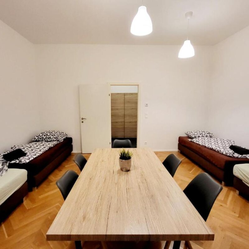Bright room with beds & dining table – 2-room apartment for short-term rental & temporary housing for 1 to 6 months in Vienna