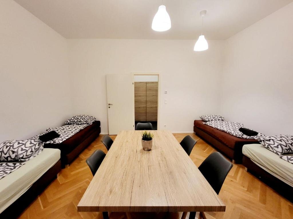 Bright room with beds & dining table – 2-room apartment for short-term rental & temporary housing for 1 to 6 months in Vienna
