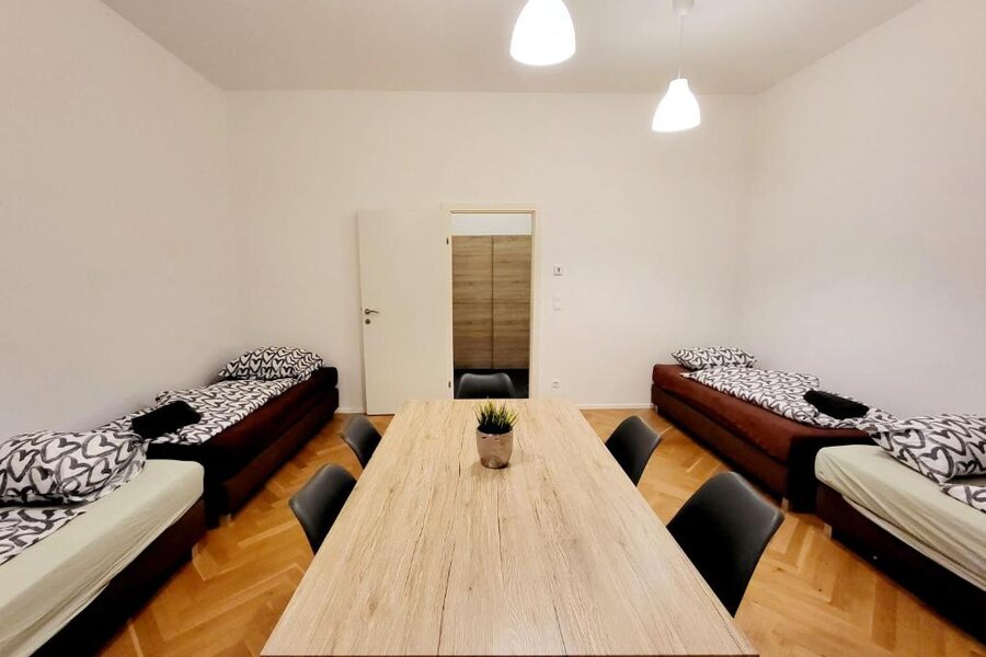 Bright room with beds & dining table – 2-room apartment for short-term rental & temporary housing for 1 to 6 months in Vienna