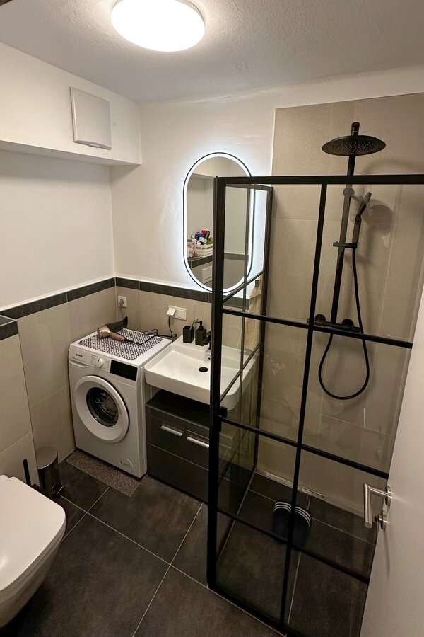 The completely renovated bathroom with stylish design, large shower and modern fittings.