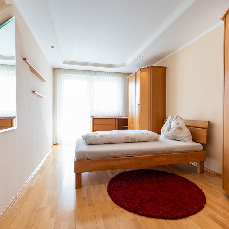 A bright bedroom with plenty of storage space: Here you'll find peace and relaxation. The large wardrobe offers ample space for your clothes.