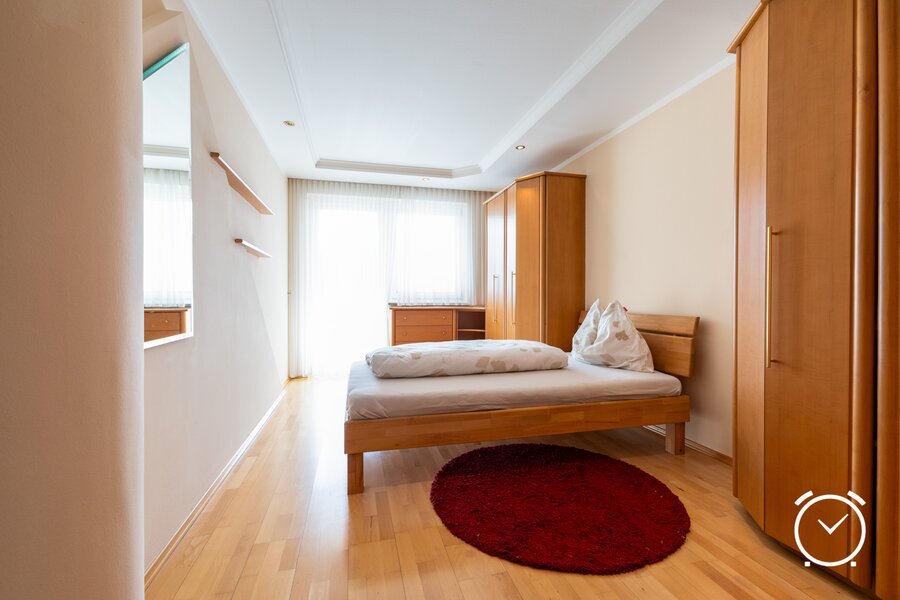 A bright bedroom with plenty of storage space: Here you'll find peace and relaxation. The large wardrobe offers ample space for your clothes.