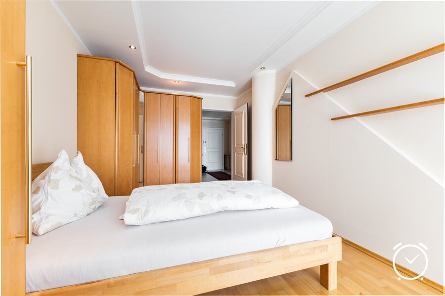 A bright bedroom with ample storage space: Here you'll find peace and relaxation. The large wardrobe offers space for your wardrobe.