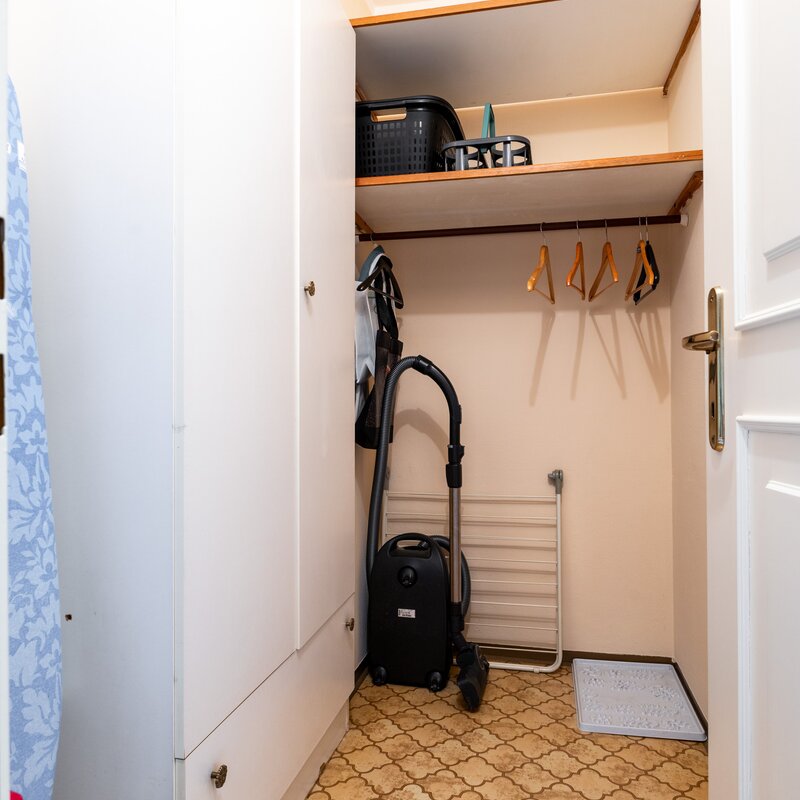 Useful storage room with shelves and clothes rail. Ideal for storing household appliances and seasonal clothing.