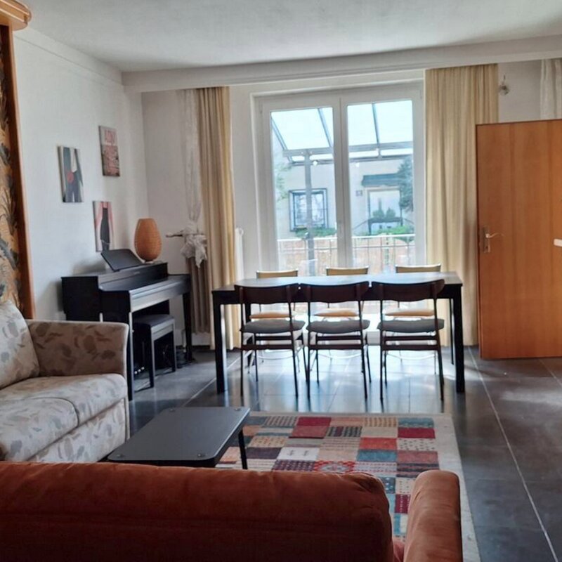 Wohnzimmer mit Kamin und Ausgang zur Terrasse