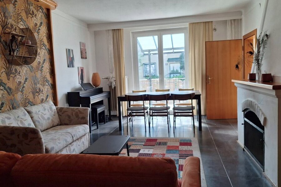 Wohnzimmer mit Kamin und Ausgang zur Terrasse