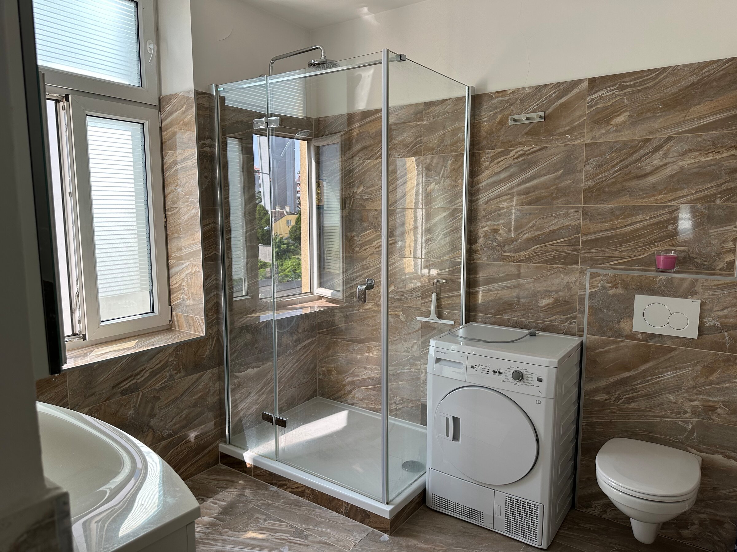 Bathroom with washing machine and dryer