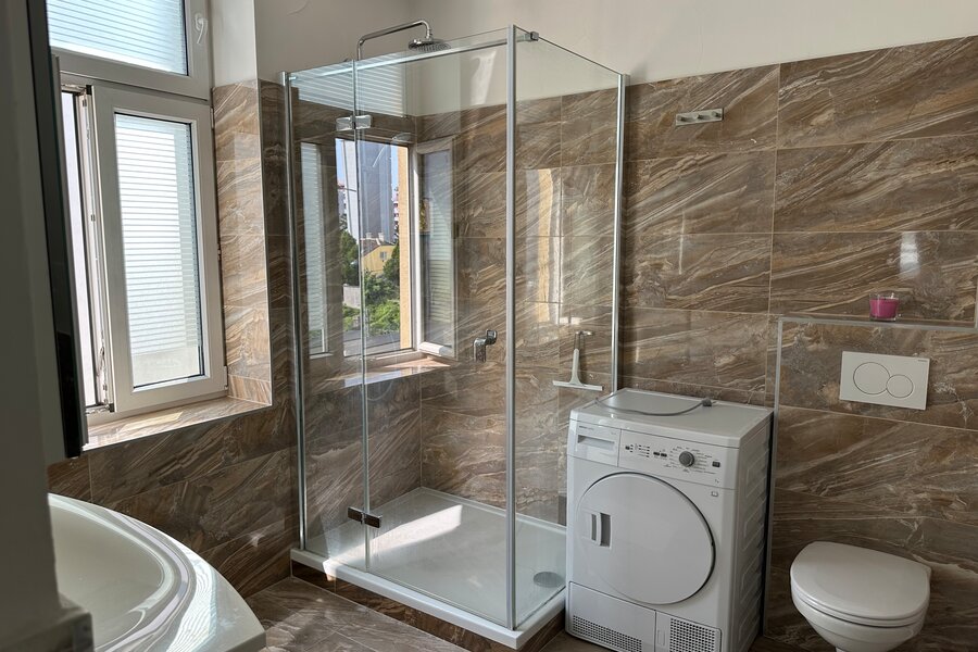 Bathroom with washing machine and dryer