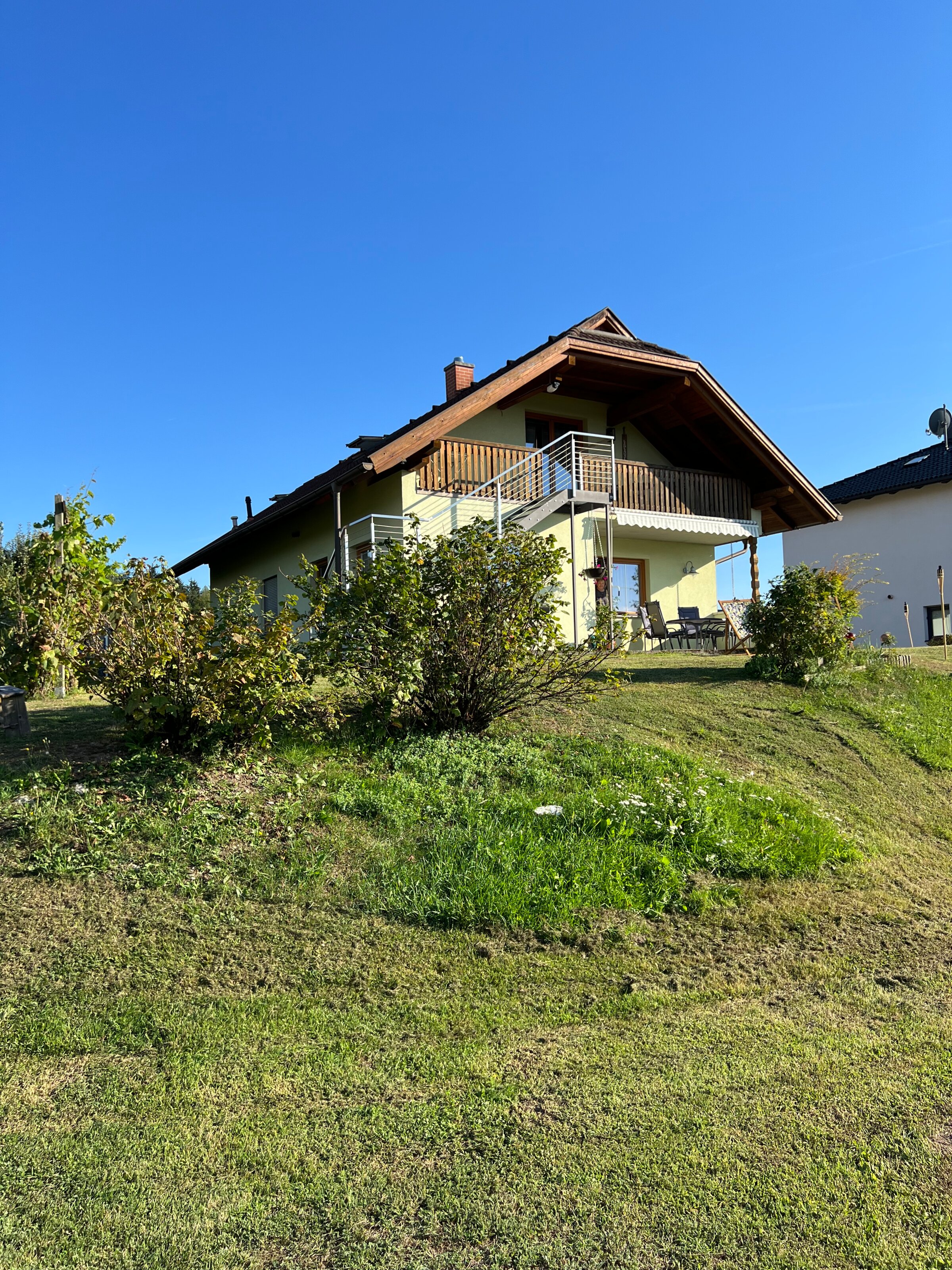 The apartment is located on the upper floor and can be accessed via an outdoor staircase.