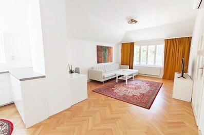 Großzügiger offener Wohnraum mit integrierter Küche und Arbeitsplatz, rechts die Tür zum Schlazimmer.