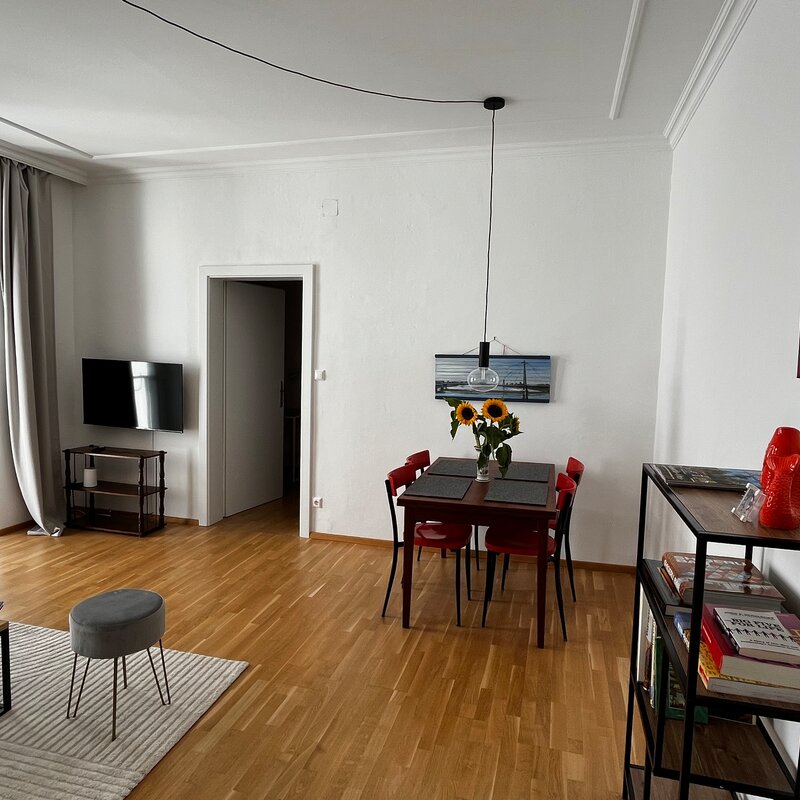Bright living area with dining table & parquet – 3-room apartment for short-term rental & temporary housing for 1 to 6 months in Vienna