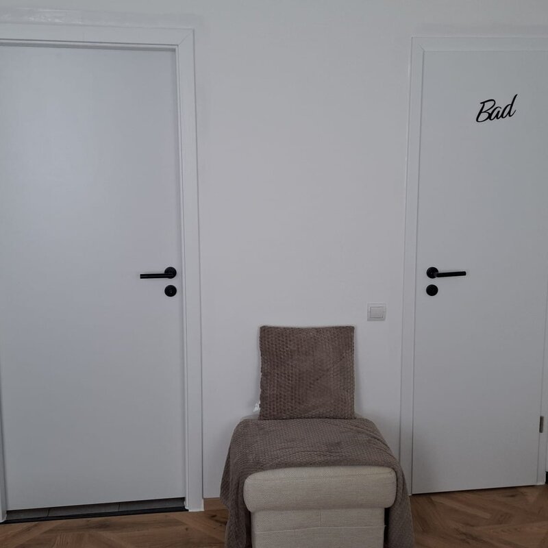 Towards the door to the kitchen/hallway and bathroom