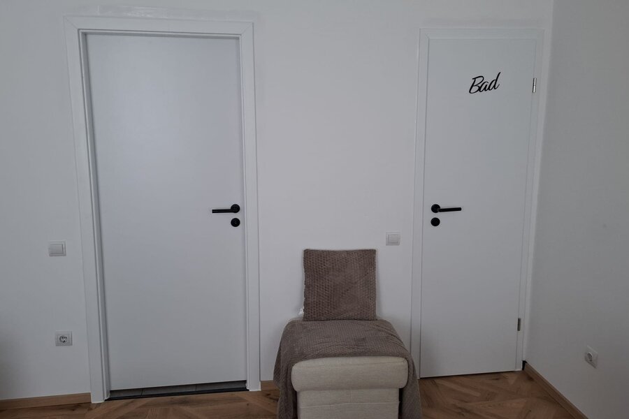 Towards the door to the kitchen/hallway and bathroom