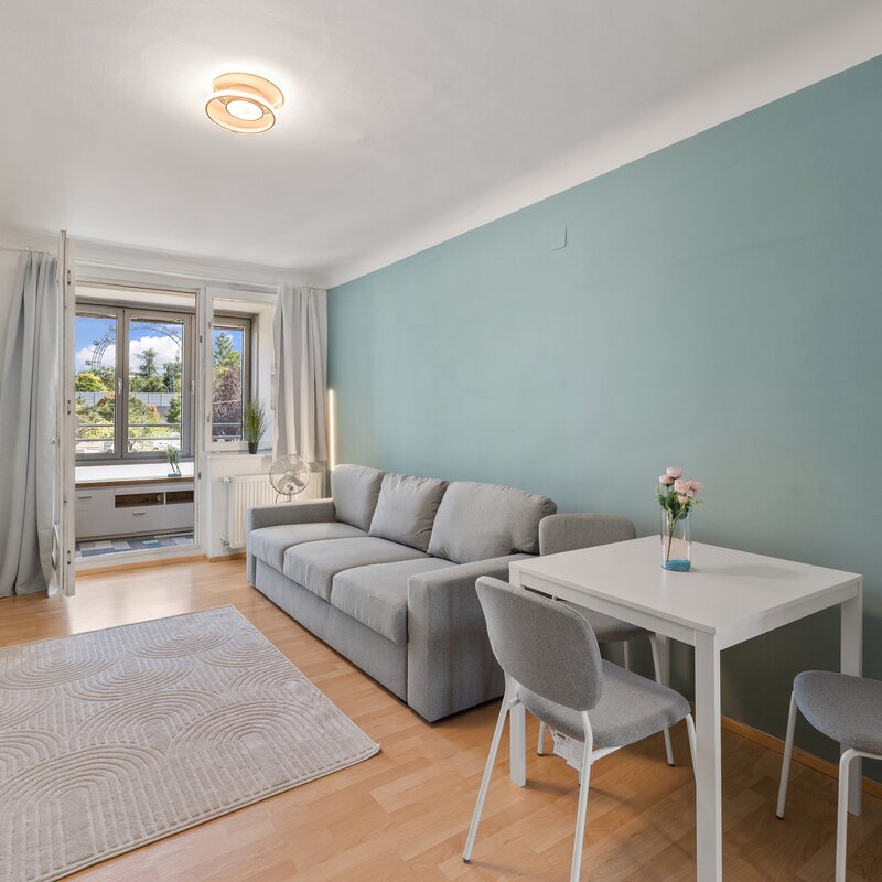 Bright living room with Ferris wheel view – 2-room apartment for short-term rental & temporary housing for 1 to 6 months in Vienna