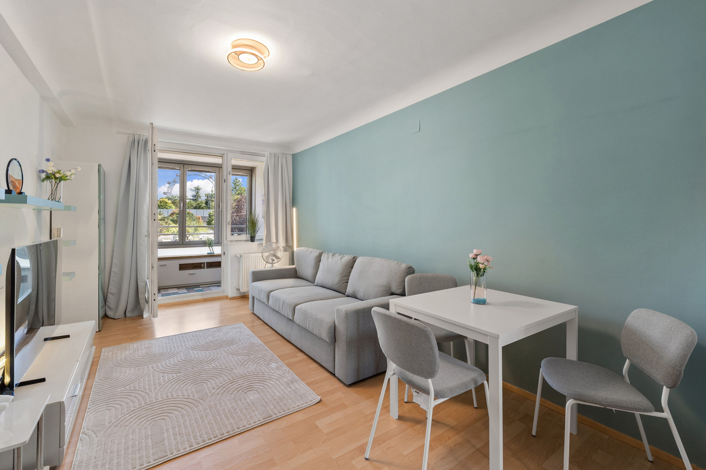 Bright living room with Ferris wheel view – 2-room apartment for short-term rental & temporary housing for 1 to 6 months in Vienna