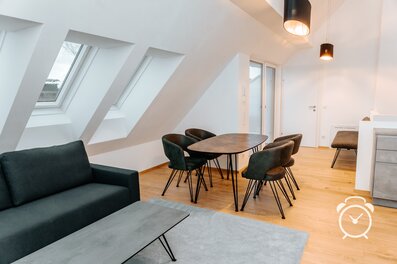 Bright living & dining area with sloped ceiling – 3-room apartment, short-term rental & temporary housing for 1 to 6 months in Salzburg