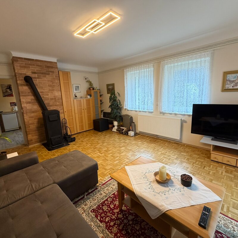 Wohnzimmer mit Kaminofen & Parkett – 2-Zimmer Wohnung, Kurzzeitmiete & Wohnen auf Zeit für 1 bis 6 Monate in Purkersdorf