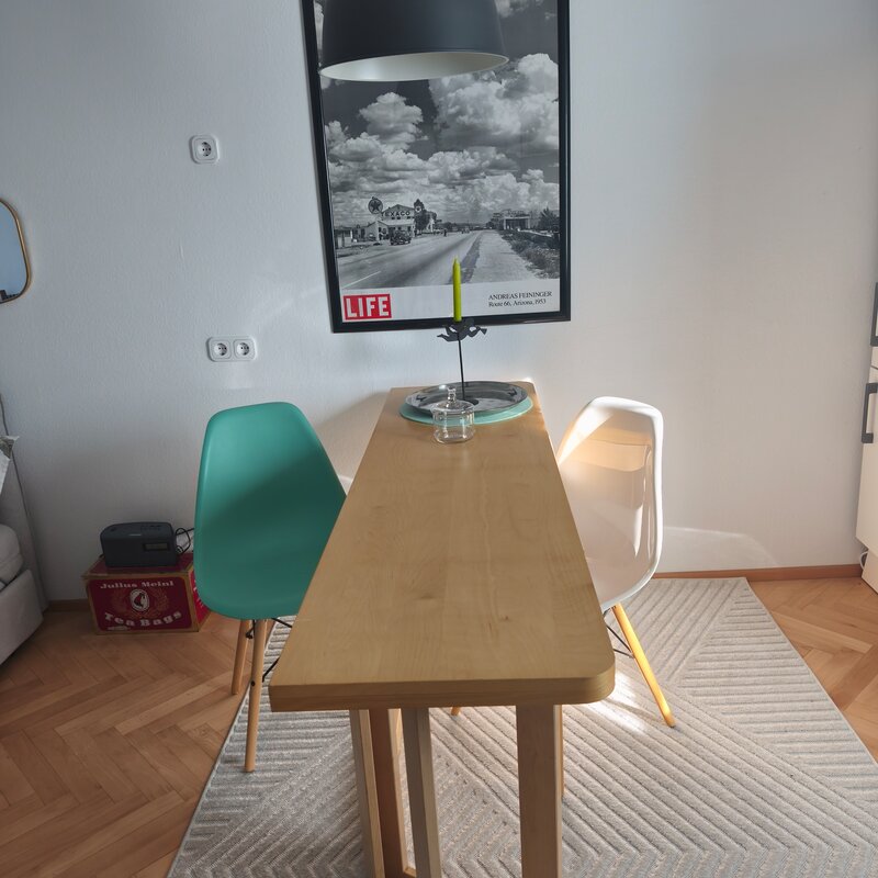 Folding table, two Eams chairs 