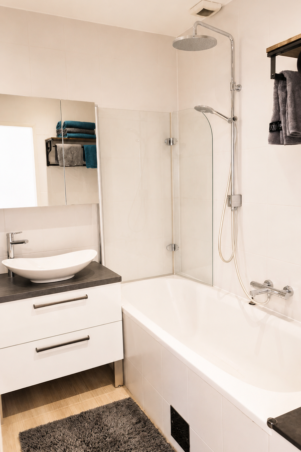 Bathroom with bathtub and rain shower