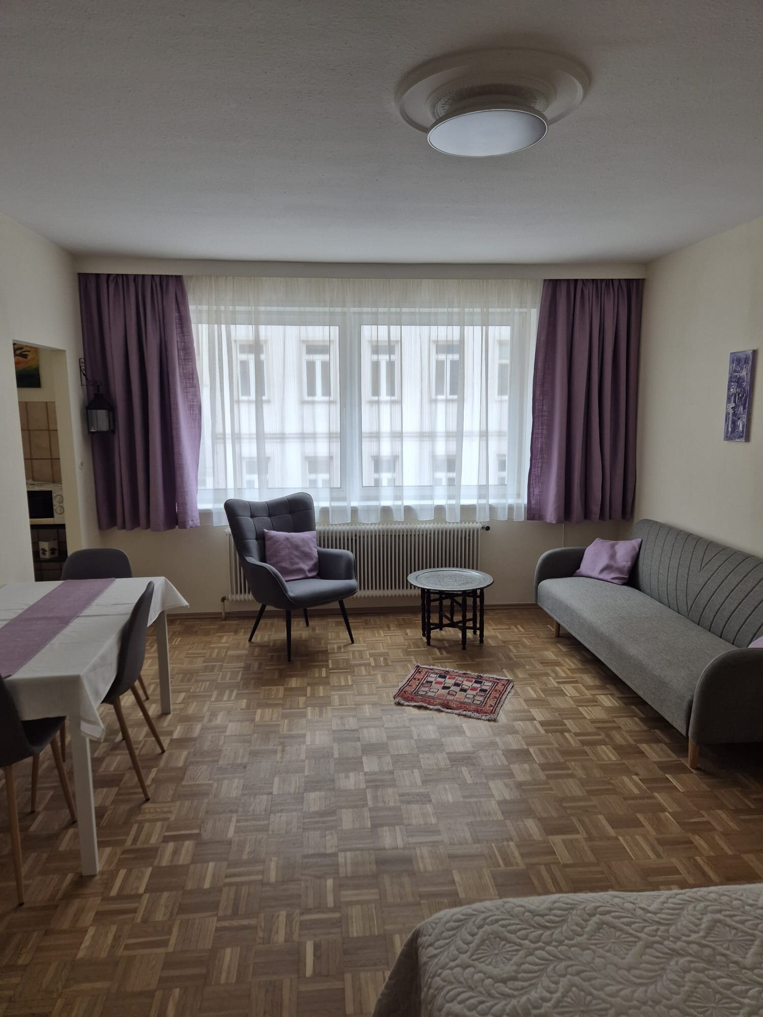 Bright living area with sofa & dining table – 1-room apartment, short-term rental Vienna, temporary housing for 1 to 6 months