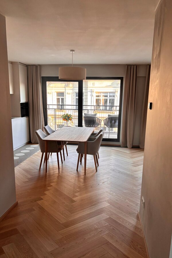 Der Blick vom Vorraum zeigt die großzügige Raumwirkung der Wohnung. Essbereich, offene Küche und Terrasse gehen harmonisch ineinander über und vermitteln sofort ein helles, modernes und einladendes Wohngefühl.