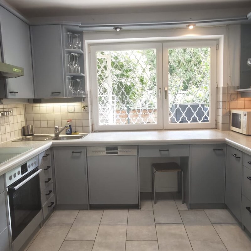 Fully equipped kitchen, including a coffee maker, dishwasher, microwave, and fridge-freezer, 