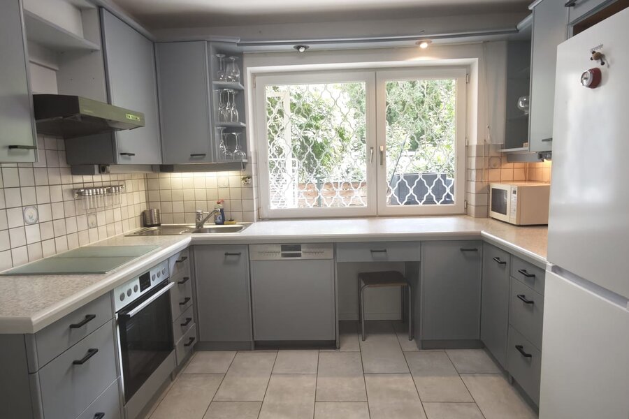 Fully equipped kitchen, including a coffee maker, dishwasher, microwave, and fridge-freezer, 