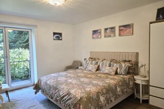 Bright bedroom with balcony & garden view – 3-room apartment, short-term rental & temporary housing for 1 to 6 months in Salzburg