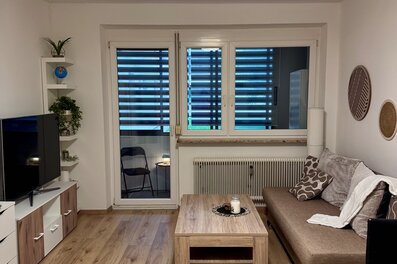 Bright living room with balcony – 2-room apartment for short-term rental & temporary housing for 1 to 6 months in Graz