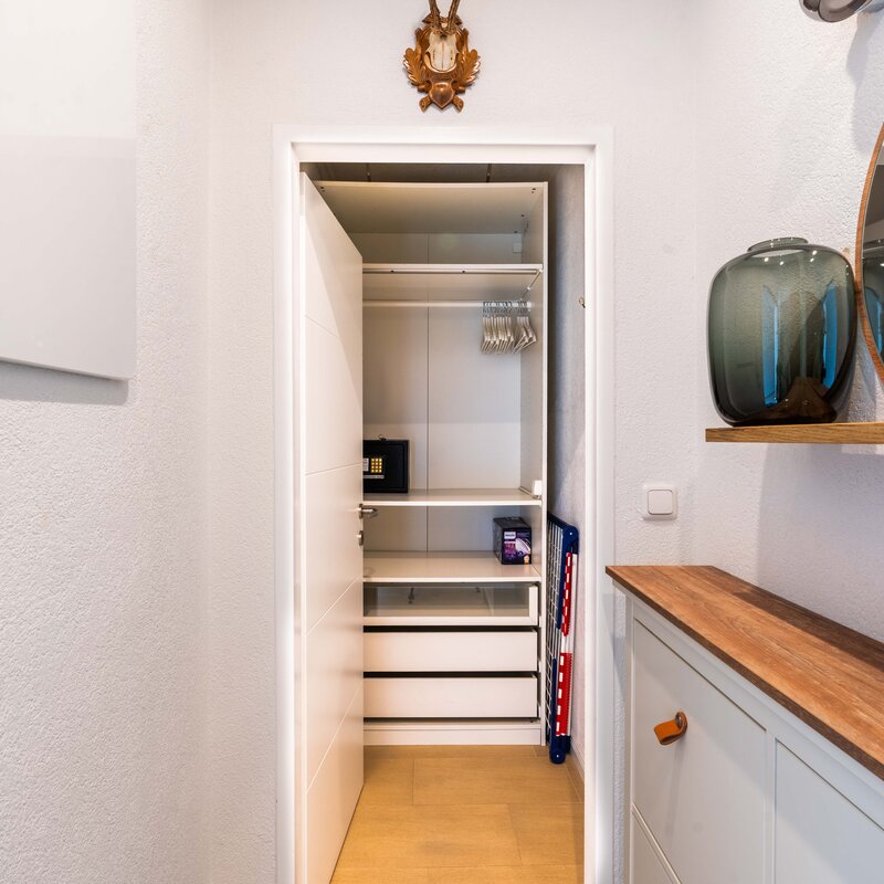 Walk-in closet, shoe cabinet, ironing board, iron, drying rack | © Anna Endres