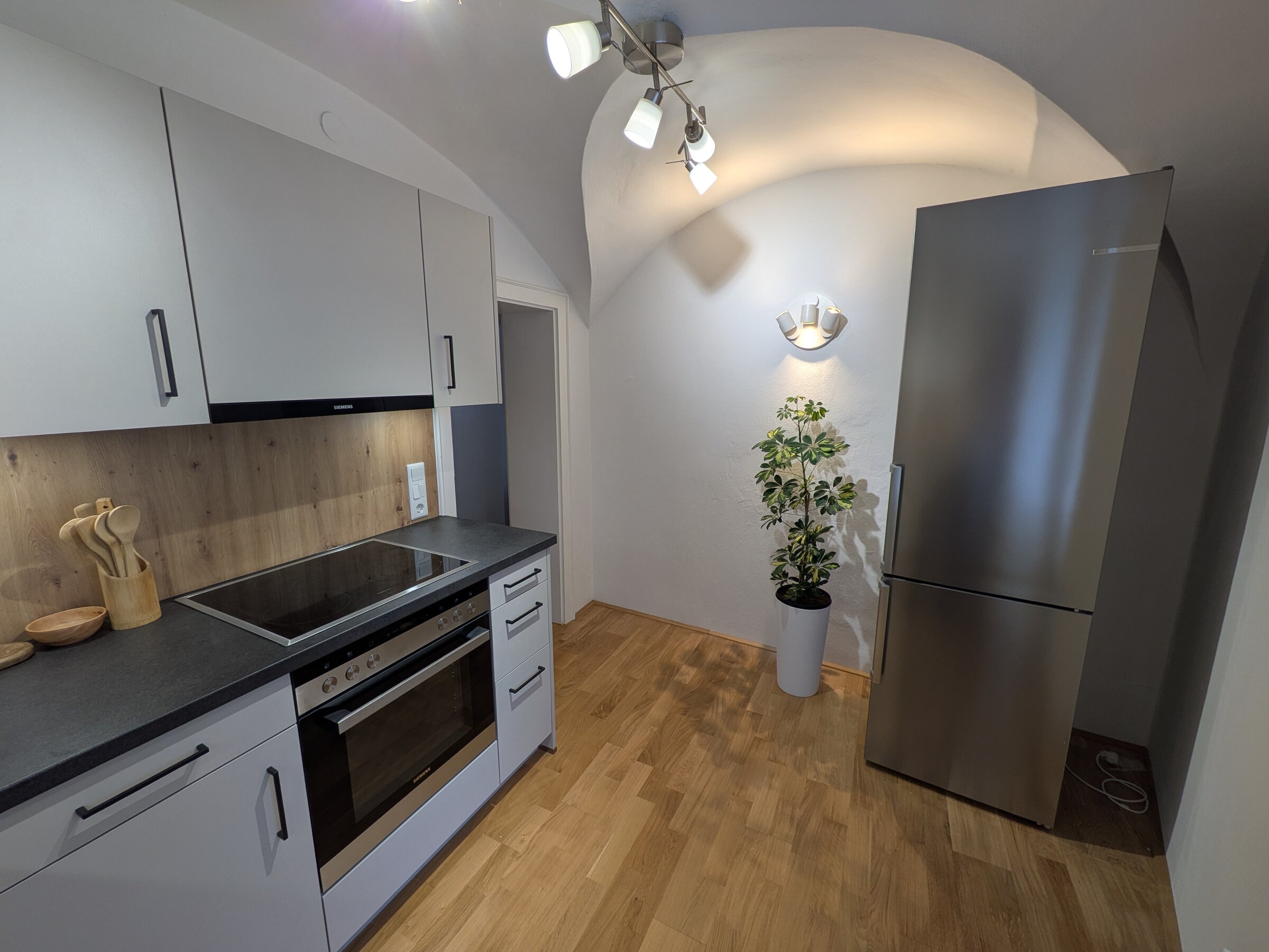 Ein klar gestalteter Küchenbereich mit hochwertigen Geräten, stilvollen Details und einem harmonischen Mix aus Holz und Edelstahl. | © Vermieter