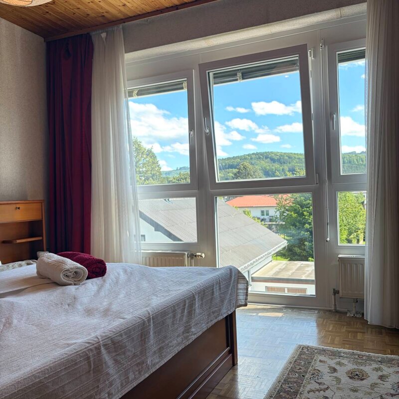 Helles Schlafzimmer mit Bergpanorama – 2-Zimmer Wohnung, Kurzzeitmiete & Wohnen auf Zeit für 1 bis 6 Monate in Schörfling