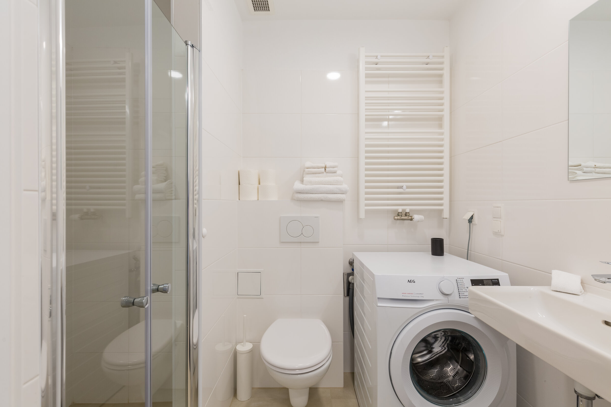 Bathroom, shower cabin, sink and washing machiene