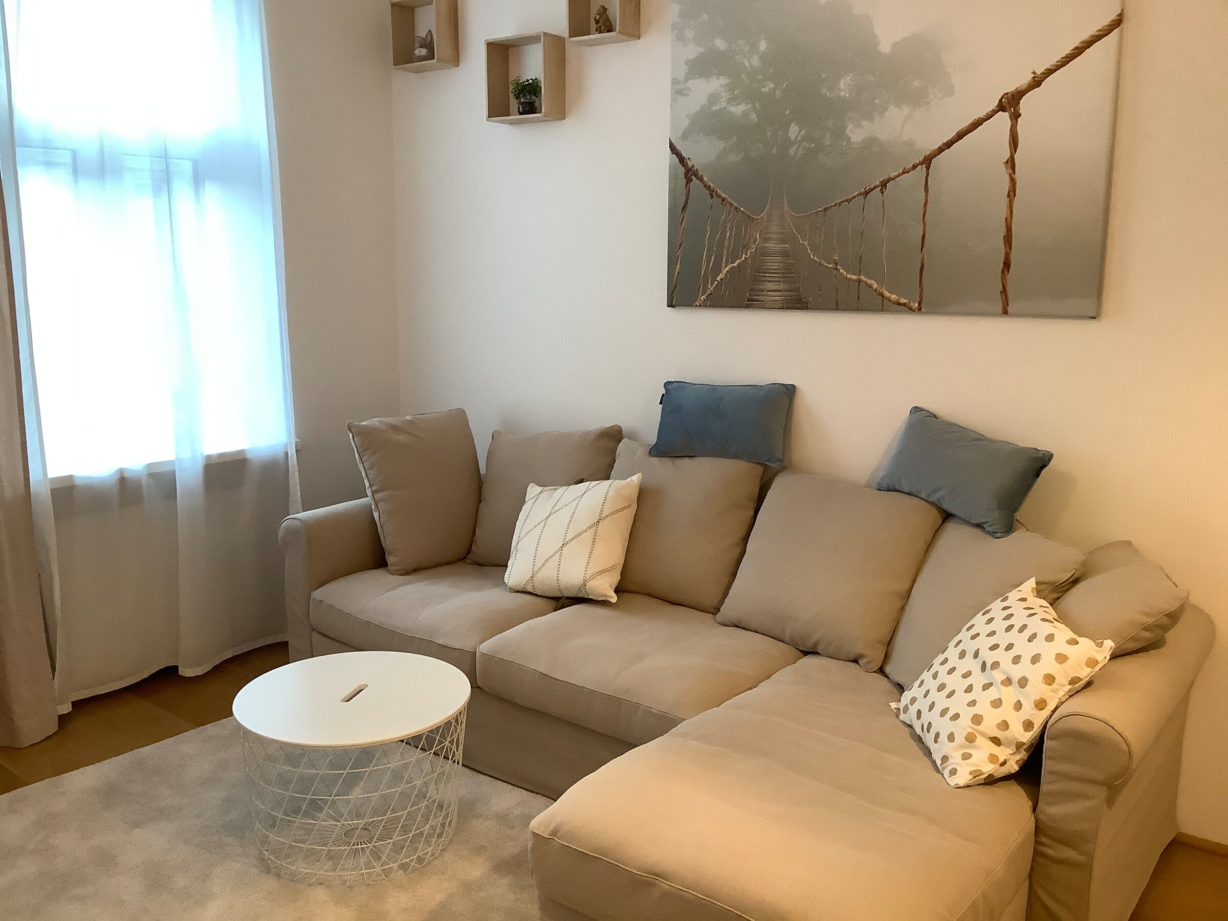 Bright living room with corner sofa & modern decor – 2-room apartment, short-term rental Vienna, 1 to 6 months