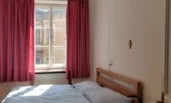 quiet bedroom with double bed and morning sun
