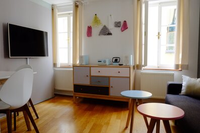 Heller Wohnbereich mit TV, Kommode & Couch – 2-Zimmer-Wohnung zur Kurzzeitmiete, Wohnen auf Zeit 1 bis 6 Monate, Salzburg
